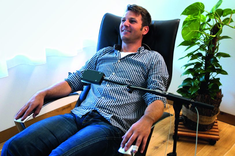 Ein Mann sitzt entspannt in einem Sessel während einer Therapiesitzung zur Behandlung von Stress